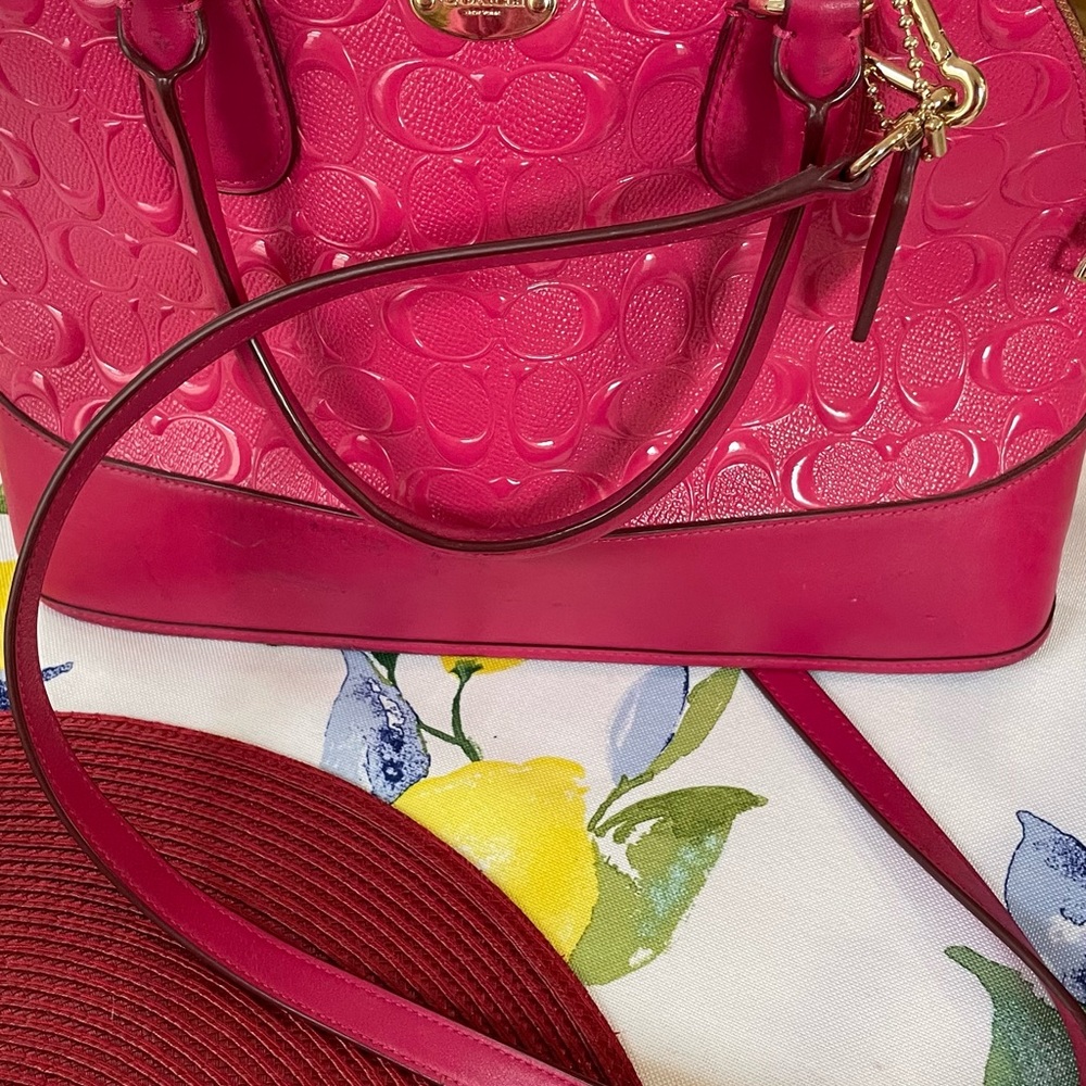 This is an used pink coach bag which is in a good condition